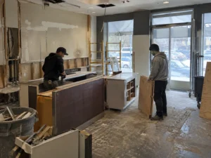 Commercial kitchenette cabinetry being removed