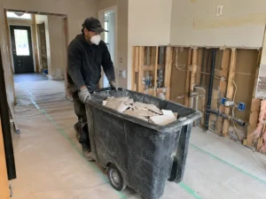 Worker collecting flooring debris