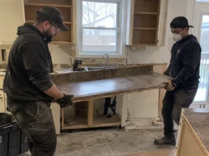 Workers carrying a removed countertop section