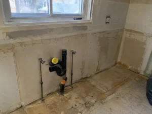Exposed services behind a removed kitchen wall finish