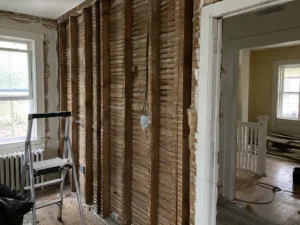 Exposed timber studs and retained lath