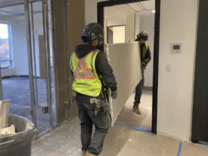 Worker reviewing an interior partition